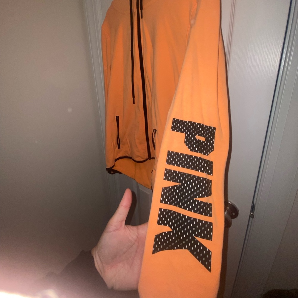 Victoria’s Secret pink jacket with hood and reflective designs.
